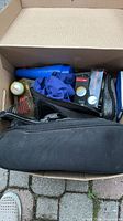 Box containing pouches, tees package, towel and accessory