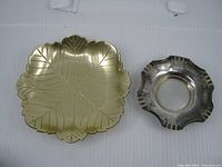 Top view leaf-pattern square brass-tone dish and fluted silver-tone dish