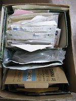 overview of box contents showing envelopes, plastic bags, stamps