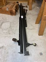 Full view of disassembled adjustable metal bed frame on floor
