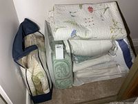 Overall lot in closet: quilt, comforter bags, blankets, linens