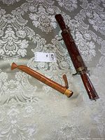 Full view of carved wood brass case and knife in sheath