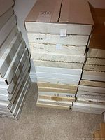 Stacks of white cardboard boxes containing the collector plates