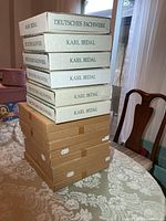 Stack of 14 boxed collector plates