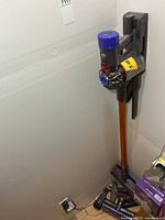 Dyson V8 Absolute vacuum mounted on wall with charger