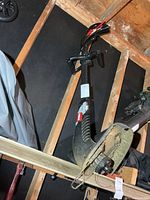Full view of Toro string trimmer hanging, showing curved shaft and handles
