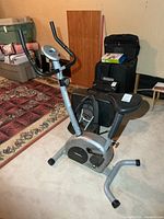 Full view of Advantage Fitness 388 exercise bike showing frame, handlebars, console and surrounding items for scale