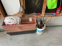 Planter boxes, bucket of tools, hand tools on shelf and wooden duck