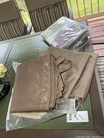 Brown side panel with grommets, straps, and sealed packaged privacy panel behind