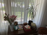 Full lot on table with vases, flowers, greeting cards, trinket boxes, live plant