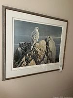 Framed Robert Bateman print on wall