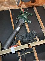 Green Yardworks electric blower-vac with attached black tube and collection bag