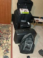 Stacked suitcases and backpack showing all items
