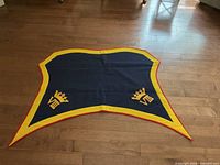 Full view of blue wool military cover showing yellow border and red piping