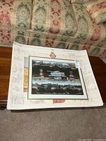 Stack showing framed Canadian Army Trophy print on top of two unframed posters