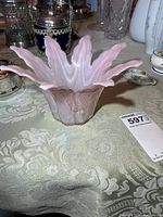 Side view of pink Murano glass dish showing flared rim and swirled pattern