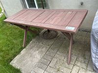 Top and side view of wooden outdoor table on patio