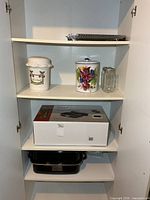 Cabinet view showing canisters, jar, roaster box, racks and tray