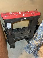 Black plastic folding sawhorses with red tops stacked together