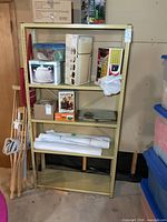 Front view of one beige metal shelving unit with five shelves