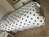 Single bed made with polka-dot bedding