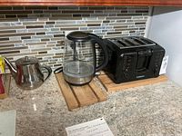 Overview of kettle, teapot and toaster on countertop