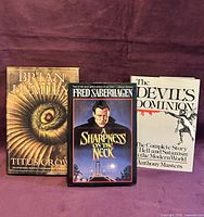 Front view of the three hardcover books standing upright