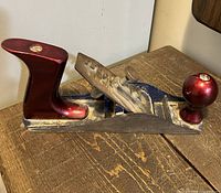 Side view of plane showing burgundy rear handle, cutter assembly and No. 1 cast mark