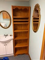 Front view of full-height honey brown pine bookcase with six shelves