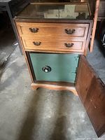 Front view of cabinet showing two drawers, open safe door