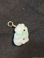 front view of jadeite monkey family pendant with 18K gold bail