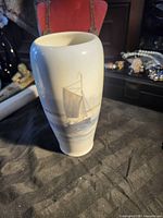 Front view showing sailboat motif on vase