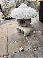 Front view of concrete pagoda lantern showing overall form and color
