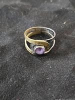 Front view showing amethyst cabochon and mixed-metal band