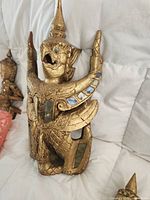 Front view of gilt wood Garuda plaque showing design and glass inlay
