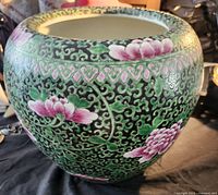 Front view showing floral and scroll design on jardiniere