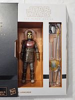 Front view of opened box showing figure and accessories