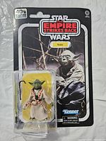 Front view of sealed Yoda action figure on card