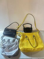 all four handbags grouped front view