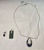 Overview of necklace, jade pendant, black charm