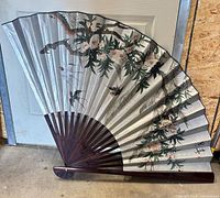 Full view of folded-open fan showing design