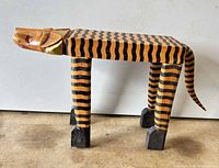 profile view of carved tiger stool