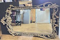 Front view of entire mirror showing ornate frame and cracked mirror glass