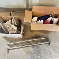Boxes containing two blue glass shades, wiring, rods, canopies