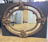 Front view showing full ornate frame and mirror