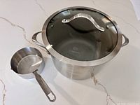 Stockpot with lid and measuring scoop overview