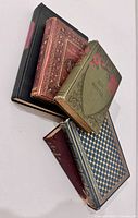 Stack showing bindings and covers of 4 of the 5 volumes
