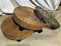 two wicker stands and plexiglass stand stacked
