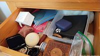 Drawer containing assorted jewelry boxes and storage containers