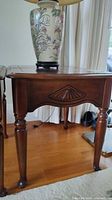 Full view of one end table showing top, apron, and legs